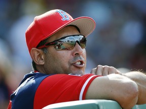 FILE - In this Aug. 26, 2017, file photo, Boston Red Sox first base coach Ruben Amaro Jr. watches from the dugout during the first inning of a baseball game against the Baltimore Orioles in Boston. The New York Mets announced that they have filled out their coaching staff, adding Gary DiSarcina, Dave Eiland and Ruben Amaro Jr. to the team. Amaro will become the first base coach and outfield instructor for new manager Mickey Callaway.  (AP Photo/Michael Dwyer, File)