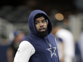 FILE - In this Sunday, Nov. 5, 2017, file photo, Dallas Cowboys running back Ezekiel Elliott warms up before an NFL football game against the Kansas City Chiefs in Arlington, Texas. Elliott has dropped his appeal on Wednesday, Nov. 15, 2017, with five games remaining on his six-game suspension over alleged domestic violence. The 22-year-old Elliott was suspended in August after the league concluded following a yearlong investigation that he had several physical confrontations in the summer of 2016 with Tiffany Thompson, his girlfriend at the time. (AP Photo/Brandon Wade, File)