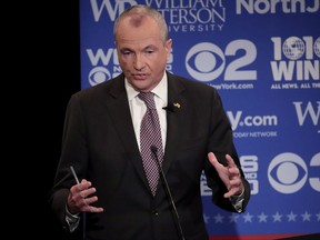 FILE - In this Oct. 18, 2017, file photo, Democratic nominee Phil Murphy participates in a gubernatorial debate against Republican nominee Lt. Gov. Kim Guadagno at William Paterson University, in Wayne, N.J. Voters in Virginia and New Jersey are picking new governors in contests that could be an early referendum on President Donald Trump. The two gubernatorial elections on Tuesday, Nov. 7, pit two mild-mannered Democrats against two Republicans who have kept the president at arm's length. (AP Photo/Julio Cortez, Pool, File)