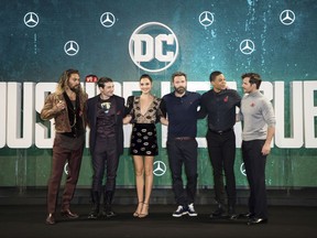 FILE - This Nov. 3, 2017 file photo shows "Justice League" cast members Jason Momoa, from left, Ezra Miller, Gal Gadot, Ben Affleck, Ray Fisher and Henry Cavill at a photo call for the film in London.  The film opens on Friday. (Photo by Vianney Le Caer/Invision/AP, File)