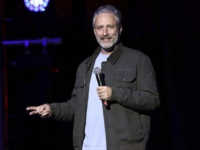 FILE - In this Nov. 10, 2015, file photo, comedian Jon Stewart performs at the 9th Annual Stand Up For Heroes event, in New York.  Stewart, John Oliver, Trevor Noah, Conan O'Brien and Red Hot Chili Peppers will perform at the annual fundraiser for the Bob Woodruff Foundation on Tuesday, Nov. 7, 2017. (Photo by Greg Allen/Invision/AP, File)