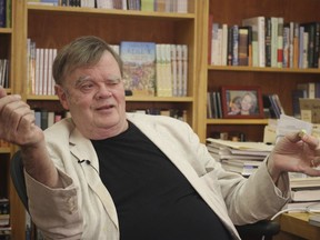 FILE - In this July 26, 2017 file photo, Garrison Keillor, creator and former host of, "A Prairie Home Companion," talks at his St. Paul, Minn., office. Keillor said Wednesday, Nov. 29, he's been fired by Minnesota Public Radio over allegations of improper behavior. (AP Photo/Jeff Baenen, File)