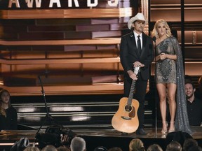 FILE - This Nov. 2, 2016 file photo shows hosts Brad Paisley, left, and Carrie Underwood at the 50th annual CMA Awards in Nashville, Tenn. The Country Music Association is warning media outlets to avoid questions about a recent mass shooting in Las Vegas, gun rights or political affiliations at their annual awards show next week or risk losing credentials. The 51st annual CMA Awards will air live on Wednesday. (Photo by Charles Sykes/Invision/AP, File)