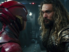 This image released by Warner Bros. Pictures shows Ezra Miller, left, and Jason Momoa in a scene from "Justice League." (Warner Bros. Entertainment Inc. via AP)