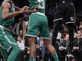 Boston Celtics' Marcus Morris (13) defends Brooklyn Nets' Rondae Hollis-Jefferson (24) during the first half of an NBA basketball game Tuesday, Nov. 14, 2017, in New York. (AP Photo/Frank Franklin II)
