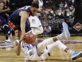 Virginia's Isaiah Wilkins (21) and Rhode Island's Jeff Dowtin (11) fight for control of the ball during the second half of an NCAA college basketball game in the championship round of the NIT Season Tip-Off tournament Friday, Nov. 24, 2017, in New York. (AP Photo/Frank Franklin II)