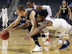 Vanderbilt's Riley LaChance, left, and Seton Hall's Myles Powell fight for control of the ball during the first half of an NCAA college basketball game in the consolation round of the NIT Season Tip-Off tournament Friday, Nov. 24, 2017, in New York. (AP Photo/Frank Franklin II)