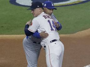 In this Friday, Oct. 27, 2017, photo, Houston Astros manager A.J. Hinch hugs Los Angeles Dodgers manager Dave Roberts before Game 3 of baseball's World Series in Houston. Roberts and Hinch are managing friends in the World Series. Roberts says it's crazy and surreal to be going against the Astros and Hinch for baseball's ultimate prize. When their families had breakfast together during the All-Star break this summer, Hinch says the two friends kind of rooted each other on. They were old Pac-10 rivals who became really good friends working together in San Diego after their playing days were done. (AP Photo/David J. Phillip)