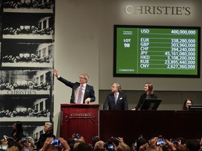 Christie's auctioneer Jussi Pylkannen, left, looks for one last bid for Leonardo da Vinci's "Salvator Mundi" at Christie's, Wednesday, Nov. 15, 2017, in New York. The painting sold at $400 million. (AP Photo/Julie Jacobson)