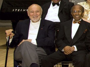 FILE - In this Jan. 11, 2011, file photo, NEA Jazz Masters George Avakian, left, and Jimmy Heath pose for a photo at the National Endowment for the Arts Jazz Master Awards Ceremony and Concert held in New York. Avakian, a Russian-born jazz scholar and architect of the American music industry who produced essential recordings by Louis Armstrong, Miles Davis and other stars has died at age 98. Avakian's daughter, Anahid Avakian Gregg, confirmed that her father died Wednesday, Nov. 22, 2017. (AP Photo/Charles Sykes, File)