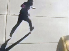 This image made from a video provided by Tawhid Kabir shows the suspect in a deadly attack running across the street with a fake gun in each hand on Tuesday, Oct. 31, 2017, in New York. The man mowed down pedestrians and cyclists along a busy bike path near the World Trade Center memorial on Tuesday, before he was shot in the abdomen by police after jumping out of the truck, authorities said. (YouTube/Tawhid Kabir via AP)