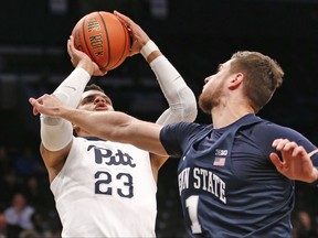 Penn State forward Deividas Zemgulis (1), of Lithuania, defends against Pittsburgh guard Shamiel Stevenson (23) who shoots for two points during the first half of an NCAA college basketball game in the Legends Classic, Monday, Nov. 20, 2017, in New York. (AP Photo/Kathy Willens)