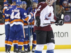 Colorado Avalanche center Matt Duchene (9) skates away as members of the New York Islanders celebrate a goal by Scott Mayfield during the first period of an NHL hockey game in New York, Sunday, Nov. 5, 2017. Duchene left the game in the the first period after he was traded to the Ottawa Senators as part of a three-way deal. (AP Photo/Kathy Willens)