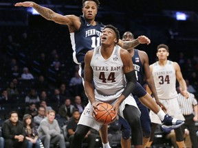 Texas A&M forward Robert Williams (44) looks for an opening with Penn State forward Lamar Stevens (11) defending during the first half of an NCAA college basketball game in the Legends Classic tournament, Tuesday, Nov. 21, 2017, in New York. (AP Photo/Kathy Willens)