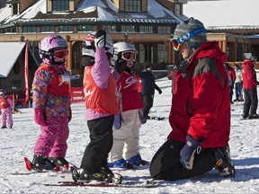 This undated photo provided by Stowe Mountain Resort in Stowe, Vt., shows an instructor with young children in a ski lesson. Kids differ in their readiness and learning styles when it comes to learning to ski, but experts say the most important thing for parents to consider is making the experience fun. (Dave Schmidt/Stowe Mountain Resort via AP)