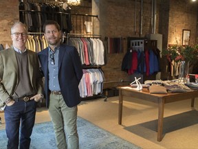 In this Tuesday, Nov. 21, 2017, photo, designer Peter Manning, left, and Jeff Hansen, CEO of Peter Manning, pose for a photo in the Peter Manning showroom in New York. The clothing retailer for men 5 feet 8 inches tall or under, tries to convey to shoppers that it offers quality at a fair price. (AP Photo/Mary Altaffer)