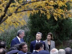 New York Mayor Bill de Blasio, left, and Argentine President Mauricio Macri visit the site of the terrorist attack on bicyclists, Monday, Nov. 6, 2017, in New York. Five Argentine bicyclists were among eight people killed by the terrorist who drove a truck down the bike path on Tuesday, Oct. 31. (AP Photo/Mark Lennihan)