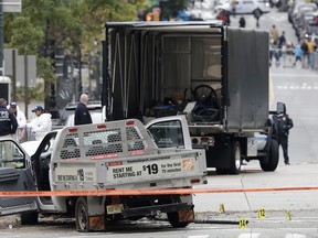 A damaged Home Depot truck remains on the scene Wednesday, Nov. 1, 2017, after the driver mowed down people on a riverfront bike path near the World Trade Center on Tuesday in New York. (AP Photo/Mark Lennihan)