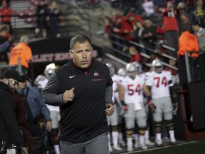 FILE- This Sept. 30, 2017 file photo shows former Rutgers football head coach, now Ohio State associate head coach/defensive coordinator Greg Schiano running onto the field before an NCAA college football game against Rutgers in Piscataway, N.J. Ohio State coach Urban Meyer says Tennessee has contacted Schiano about its head coaching vacancy. Meyer didn't have any additional details about Tennessee's potential interest in his defensive coordinator. Tennessee is seeking a new coach after firing Butch Jones two weeks ago. Schiano posted a 68-67 record as Rutgers' coach from 2001-11. (AP Photo/Mel Evans, file)