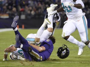 This Oct. 26, 2017 photo shows Miami Dolphins middle linebacker Kiko Alonso, top left, colliding with Baltimore Ravens quarterback Joe Flacco in the first half of an NFL football game in Baltimore. In their return from a three-day break, the Ravens provide an eagerly anticipated update on Flacco, who sustained a concussion in a 40-0 win over Miami and hopes to be ready for Sunday's game at Tennessee. (AP Photo/Nick Wass)