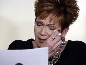Beverly Young Nelson, the latest accuser of Alabama Republican Roy Moore, reads her statement at a news conference, in New York, Monday, Nov. 13, 2017. Nelson says Moore assaulted her when she was 16 and he offered her a ride home from a restaurant where she worked. Moore says the latest allegations against him are a "witch hunt." (AP Photo/Richard Drew)