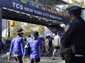 A New York City police office stands near the finish line of the New York City Marathon, in New York's Central Park, Friday, Nov. 3, 2017. New York City police say they're prepared with increased security for the marathon this weekend, days after eight people were killed not far from the World Trade Center in a terrorist attack when a man driving a rented truck mowed people down on a bicycle path. (AP Photo/Richard Drew)