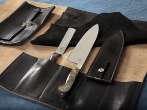 The Town Cutler Chef Kit, that consists of their Black Leather 5-Slot Knife Wrap, an 8.5-inch AEB-L Stainless Steel Chef Knife with Buckeye Burl Handle and leather scabbard, right, and a 4-inch Charcoal Palette Knife, is shown in this photograph in New York, Tuesday, Oct. 31, 2017. (AP Photo/Richard Drew)