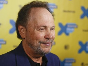 FILE - In this Sunday, March 15, 2015, file photo, actor Billy Crystal walks the red carpet for "The Comedians" during the South by Southwest Film Festival in Austin, Texas. A report of a car crashing into a pizza and ice cream shop on Long Island, early Monday, Nov. 20, 2017, turned out to be a scene for a film starring Crystal. Authorities were aware a film was being shot there but sent emergency crews just in case a real crash had occurred. (Photo by Jack Plunkett/Invision/AP, File)