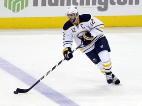 FILE- This March 28, 2017, file photo shows Buffalo Sabres forward Brian Gionta carrying the puck against the Columbus Blue Jackets during an NHL hockey game in Columbus, Ohio.  For someone once constantly reminded of being too small to have an NHL future, Gionta is enjoying a few last laughs entering the twilight of his career. At 38, the 5-foot-7, 180-pound forward has no regrets with the decision he made last summer to put family and flag first to forego a chance at playing a 17th NHL season. Rejecting at least one contract offer in July because it would've meant relocating his wife and three children, Gionta chose to pursue an opportunity to represent the United States at the Winter Olympics in Pyeongchang, South Korea, in February. (AP Photo/Paul Vernon, File)