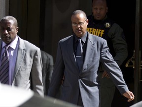 FILE - In this June 10, 2016, file photo, Officer Caesar Goodson, center, leaves the courthouse after his trial in the death of Freddie Gray in Baltimore. A Baltimore police officer involved in arresting Freddie Gray, who later suffered a fatal injury during a police van ride, testified at the driver's disciplinary hearing Tuesday, Oct. 31, 2017 that Gray did not show any signs he needed medical care when he was first put into the van. Officer Edward Nero testified at the hearing for Officer Goodson, the van driver who could be fired for violating department policies in the case. (AP Photo/Jose Luis Magana, File)