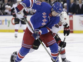 New York Rangers' Jimmy Vesey, left, and Ottawa Senators' Christopher DiDomenico compete for the puck during the first period of the NHL hockey game, Sunday, Nov. 19, 2017, in New York. (AP Photo/Seth Wenig)