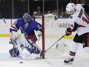 New York Rangers goalie Henrik Lundqvist, left, defends against a shot by Ottawa Senators' Alexandre Burrows during the third period of the NHL hockey game, Sunday, Nov. 19, 2017, in New York. The Rangers defeated the Senators 3-0. (AP Photo/Seth Wenig)