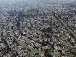 2017 AP YEAR END PHOTOS - Homes burned by a wildfire are seen on Oct. 11, 2017, in Santa Rosa, Calif. Wildfires whipped by powerful winds swept through Northern California sending residents on a headlong flight to safety through smoke and flames as homes burned. (AP Photo/Jeff Chiu)