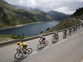 2017 AP YEAR END PHOTOS - Britain's Chris Froome, wearing the overall leader's yellow jersey, is followed by Italy's Fabio Aru as they climb Croix de Fer pass during the seventeenth stage of the Tour de France cycling race over 183 kilometers (113.7 miles) with a start in La Mure and finish in Serre-Chevalier, France, on July 19, 2017. (AP Photo/Christophe Ena)