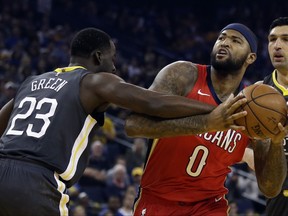 Golden State Warriors' Draymond Green, left, defends against New Orleans Pelicans center DeMarcus Cousins (0) during the first half of an NBA basketball game Saturday, Nov. 25, 2017, in Oakland, Calif. (AP Photo/Ben Margot)