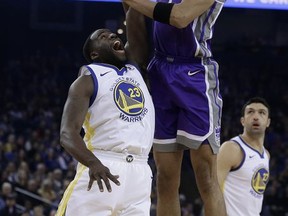 Sacramento Kings' Skal Labissiere (7) shoots over Golden State Warriors' Draymond Green, left, during the first half of an NBA basketball game, Monday, Nov. 27, 2017, in Oakland, Calif. (AP Photo/Ben Margot)