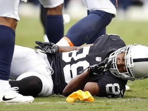 Oakland Raiders wide receiver Amari Cooper (89) remains on the ground after a hit by the Denver Broncos during the first half of an NFL football game in Oakland, Calif., Sunday, Nov. 26, 2017. (AP Photo/D. Ross Cameron)
