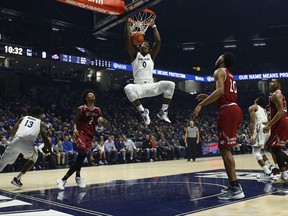 Xavier Musketeers forward Tyrique Jones dunks the ball after making a move past Rider Broncs guard Jordan Allen during the first half of an NCAA college basketball game, Monday, Nov. 13, 2017, in Cincinnati. (AP Photo/Aaron Doster)