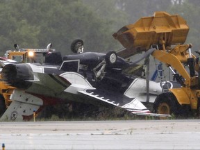 FILE – This June 23, 2017, file photo shows a military jet that ran off a runway and flipped over following a practice flight for the Dayton Air Show at Dayton International Airport in Dayton, Ohio.  The U.S. Air Force concluded Friday, Nov. 3,  that a Thunderbirds pilot was going too fast in bad weather and without enough stopping distance when landing on a wet runway, causing a crash that destroyed a $29 million F-16D jet during practice for the Dayton air show in Ohio.  (Ty Greenlees/Dayton Daily News via AP, File)