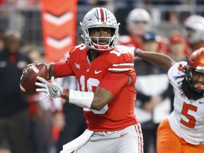 Ohio State quarterback J.T. Barrett drops back to pass against Illinois during the first half of an NCAA college football game Saturday, Nov. 18, 2017, in Columbus, Ohio. (AP Photo/Jay LaPrete)