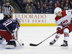 Columbus Blue Jackets' Joonas Korpisalo, left, of Finland, makes a save against Carolina Hurricanes' Derek Ryan during the first period of an NHL hockey game Tuesday, Nov. 28, 2017, in Columbus, Ohio. (AP Photo/Jay LaPrete)