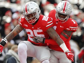 Ohio State running back Mike Weber, left, celebrates his touchdown against Michigan State with teammate Johnnie Dixon during the first half of an NCAA college football game Saturday, Nov. 11, 2017, in Columbus, Ohio. (AP Photo/Jay LaPrete)