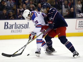 New York Rangers forward Jimmy Vesey, left, works against Columbus Blue Jackets defenseman Seth Jones during the first period of an NHL hockey game in Columbus, Ohio, Friday, Nov. 17, 2017. (AP Photo/Paul Vernon)