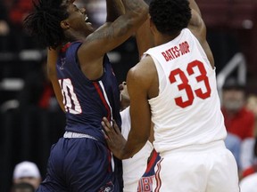 Robert Morris forward Koby Thomas, left, goes up for a shot against Ohio State forward Keita Bates-Diop during the first half of an NCAA college basketball game in Columbus, Ohio, Friday, Nov. 10, 2017. (AP Photo/Paul Vernon)