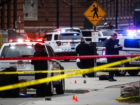FILE – In this Nov. 28, 2016, file photo, crime scene investigators collect evidence from the pavement as police respond to an attack on the Ohio State University campus in Columbus, Ohio. In a video released Monday, Nov. 27, 2017, before the anniversary of the attack, Ohio State University Police officer Alan Horujko credits his training for allowing him to quickly stop the man responsible, according to a video released Monday, Nov. 27, 2017. Horujko shot and killed Abdul Razak Ali Artan after the 18-year-old drove into a crowd outside a classroom building and attacked people with a knife. (AP Photo/John Minchillo, File)