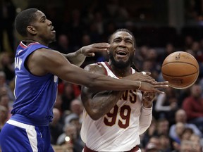 Los Angeles Clippers' Jawun Evans, left, knocks the ball loose from Cleveland Cavaliers' Jae Crowder during the first half of an NBA basketball game, Friday, Nov. 17, 2017, in Cleveland. (AP Photo/Tony Dejak)