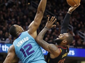 Cleveland Cavaliers' LeBron James, right, shoots over Charlotte Hornets' Dwight Howard in the first half of an NBA basketball game, Friday, Nov. 24, 2017, in Cleveland. (AP Photo/Tony Dejak)