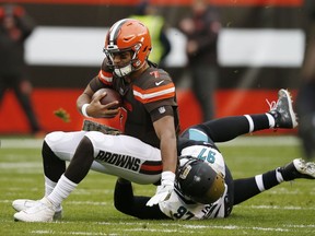 Cleveland Browns quarterback DeShone Kizer (7) is sacked by Jacksonville Jaguars defensive tackle Malik Jackson (97) in the first half during an NFL football game, Sunday, Nov. 19, 2017, in Cleveland. (AP Photo/Ron Schwane)