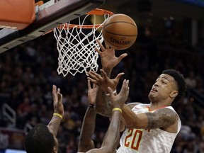 Atlanta Hawks' John Collins (20) and Cleveland Cavaliers' JR Smith (5) battle for a rebound in the first half of an NBA basketball game, Sunday, Nov. 5, 2017, in Cleveland. (AP Photo/Tony Dejak)