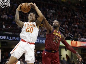 Atlanta Hawks' John Collins (20) grabs a rebound ahead of Cleveland Cavaliers' Jeff Green (32) in the second half of an NBA basketball game, Sunday, Nov. 5, 2017, in Cleveland. (AP Photo/Tony Dejak)